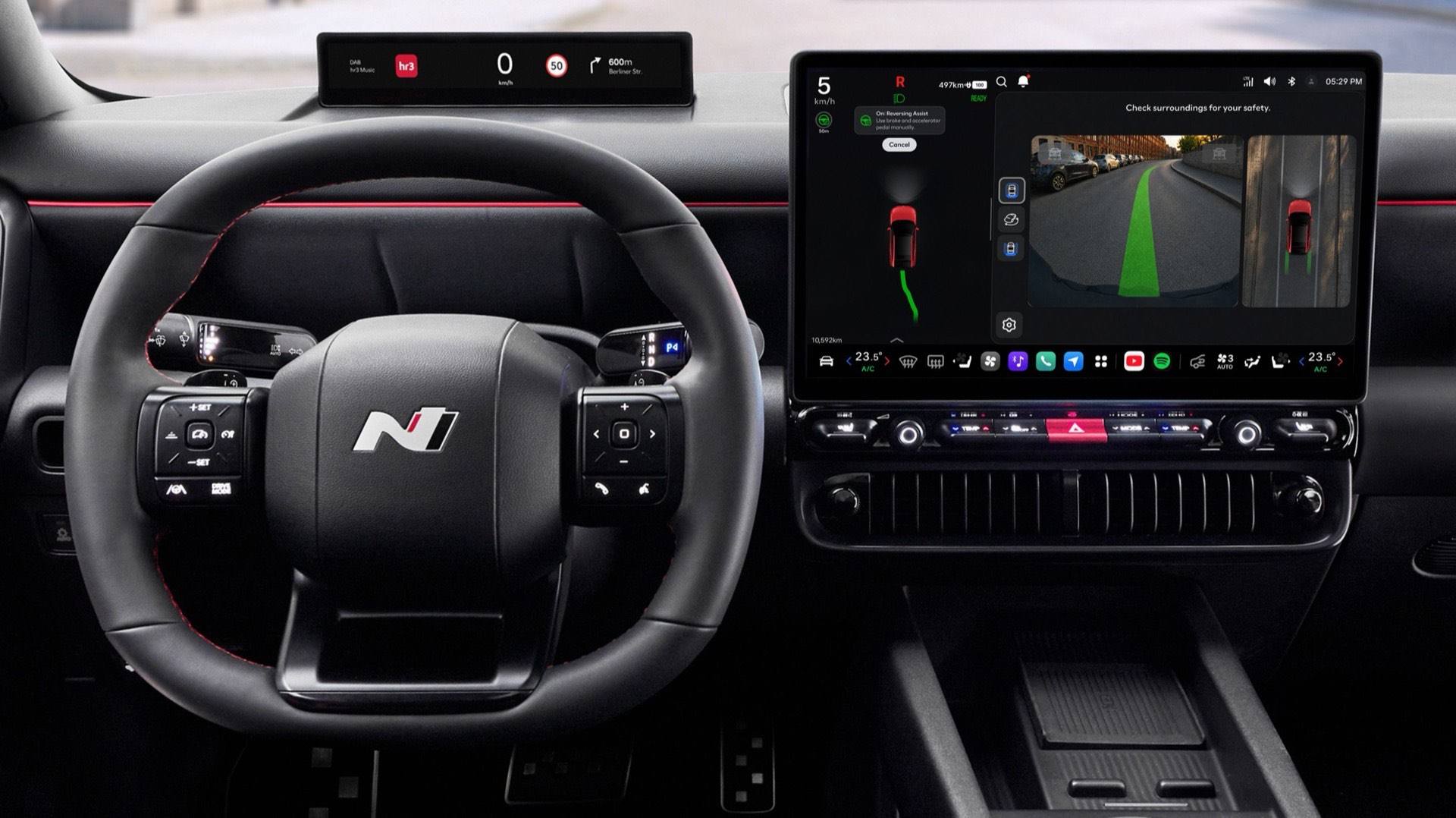 Close up of N Line steering wheel, center display inside the black Hyundai IONIQ 3 N Line interior.