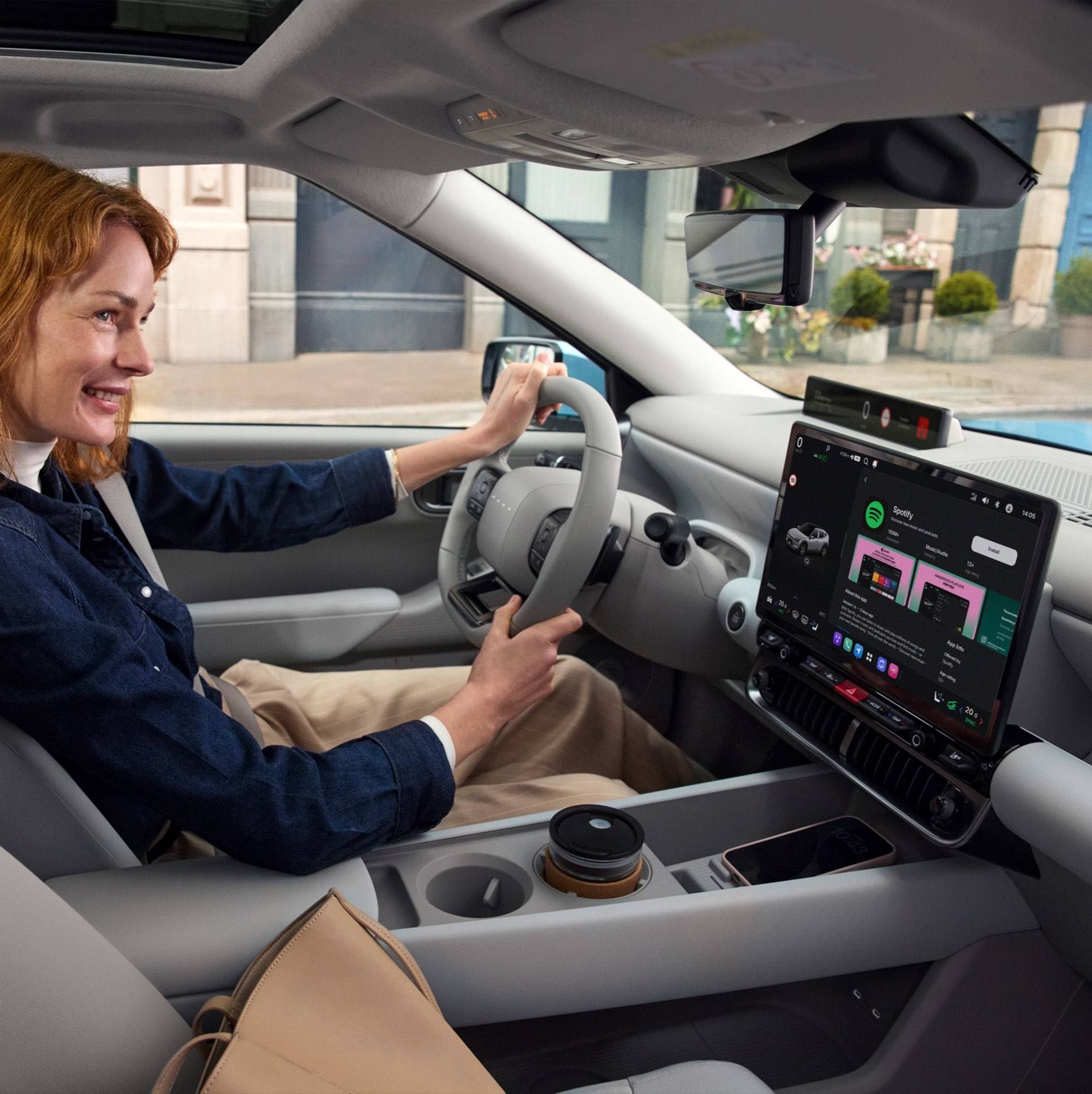 Woman in the driver's seat inside the Hyundai IONIQ 3.