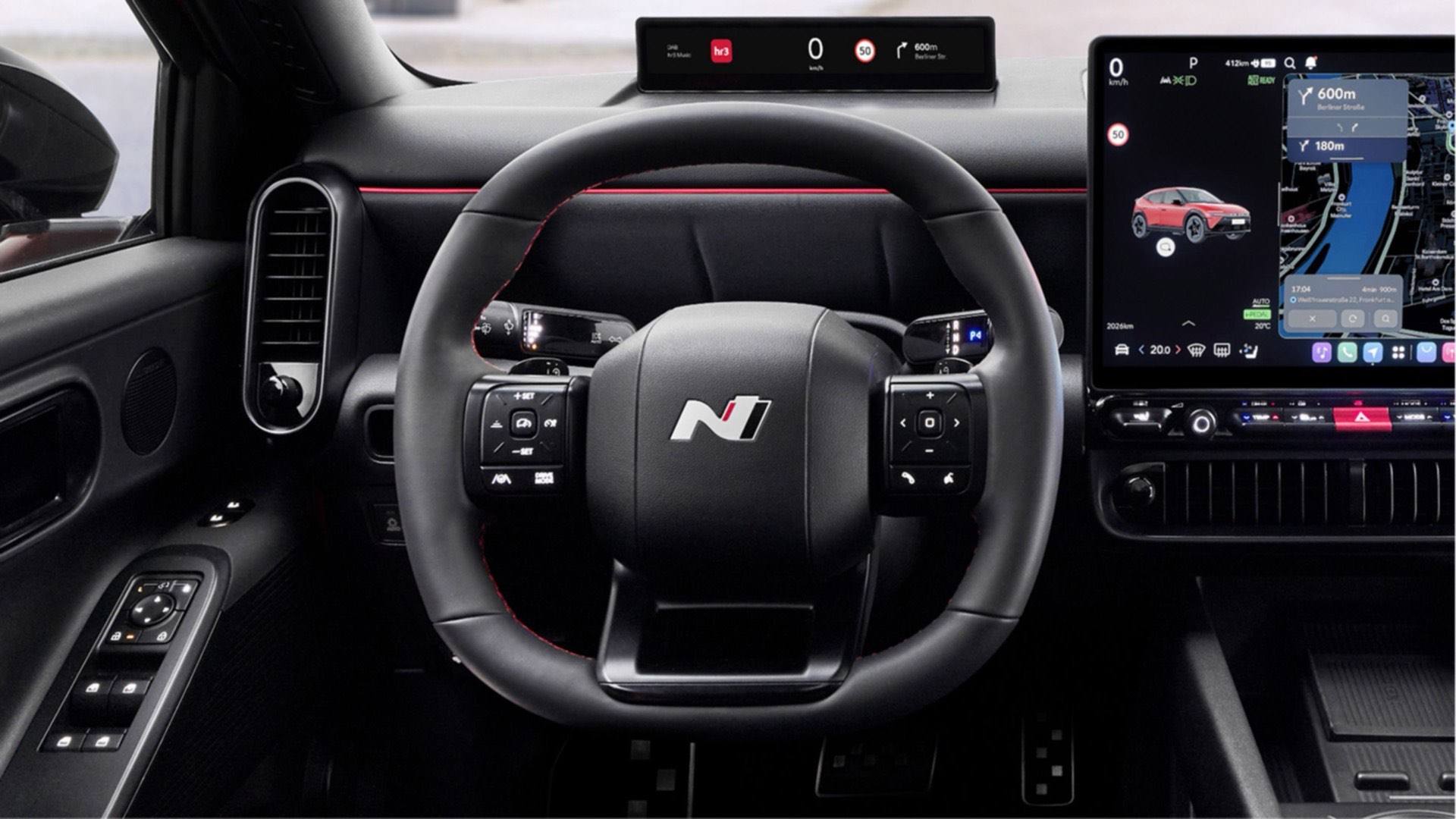 Close up of N Line steering wheel, center display inside the black Hyundai IONIQ 3 N Line interior.